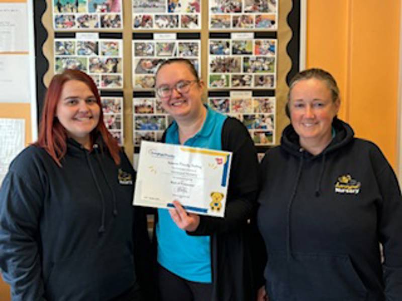 Members of the Honeypot Nursery team with their certificate.