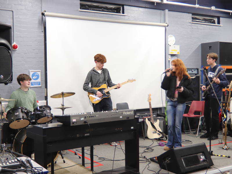 Music students in Music Technology studio on stage with instruments