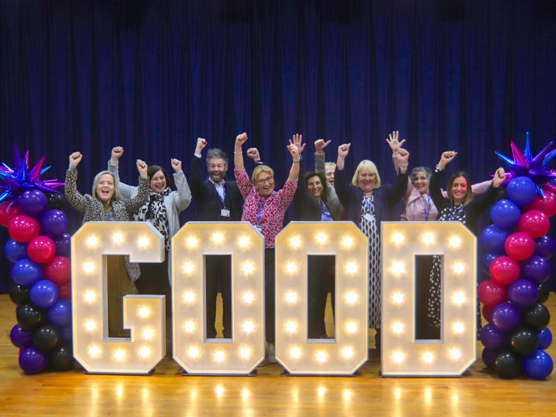 City of Portsmouth Colleges' Senior Leadership team surrounding good in light up letters