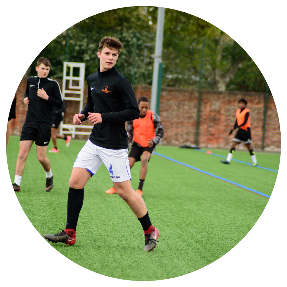 A male Global student playing football at City of Portsmouth College 