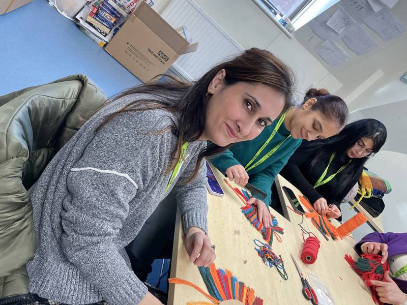 Female ESOL student at the macrame workshop.