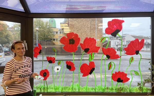 Keira with her stunning images of poppies at our Arundel Campus.