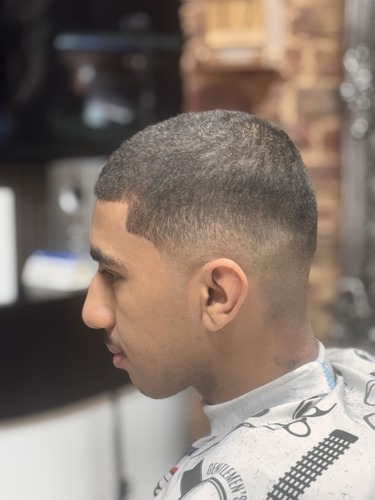 A young male having his hair cut at Retreat Salons, City of Portsmouth College