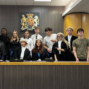 COPC students stand at the bench at a Portsmouth court following a mock trial experience