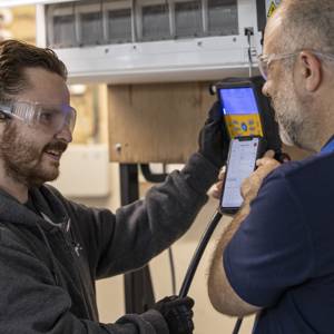 A student gets tuition from a lecturer in Refrigeration and Air Conditioning