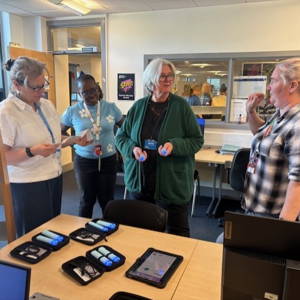 A group of local education providers test assistive technology at the launch of the Assistive Technology Lending Library at City of Portsmouth College