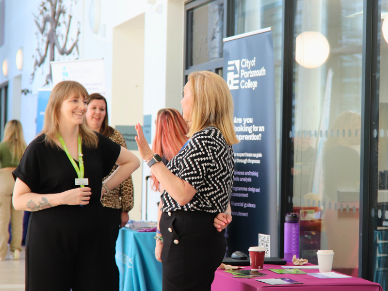 Friendly staff ready and waiting to talk about apprenticeship opportunities at a City of Portsmouth College open event.