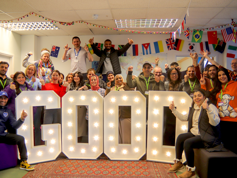 Students and staff at City of Portsmouth Colleges' Arundel Campus surrounding good in light up letters