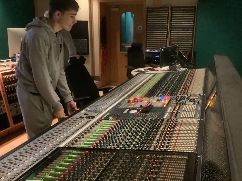 Male student seen on a mixing desk at the Abbey Road Institute