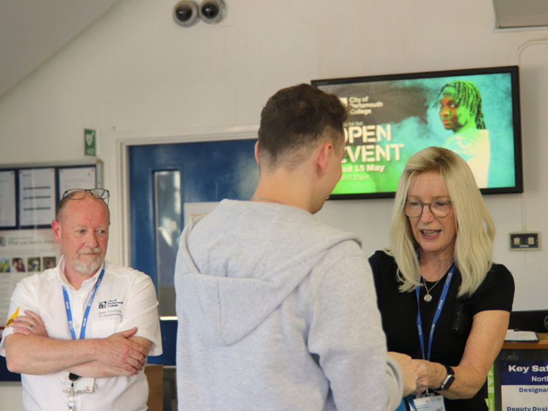 Staff welcome a potential student to City of Portsmouth College North Harbour Campus Open Event, May 2024.