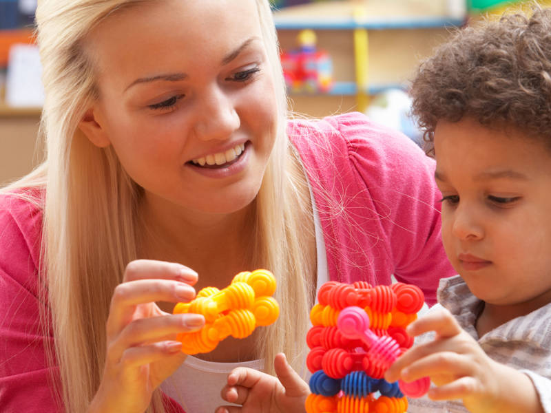 Female student seen with young child as part of her Level 3 Teaching Assistant Pathways Apprenticeship.